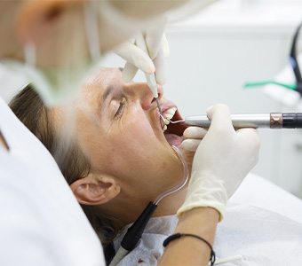 Man relaxing in dental chair with IV dental sedation