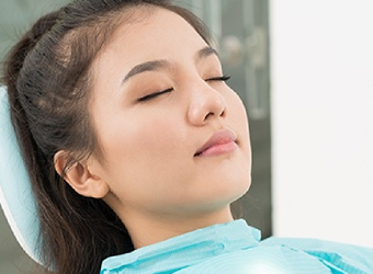 Man relaxing in dental chair with IV dental sedation