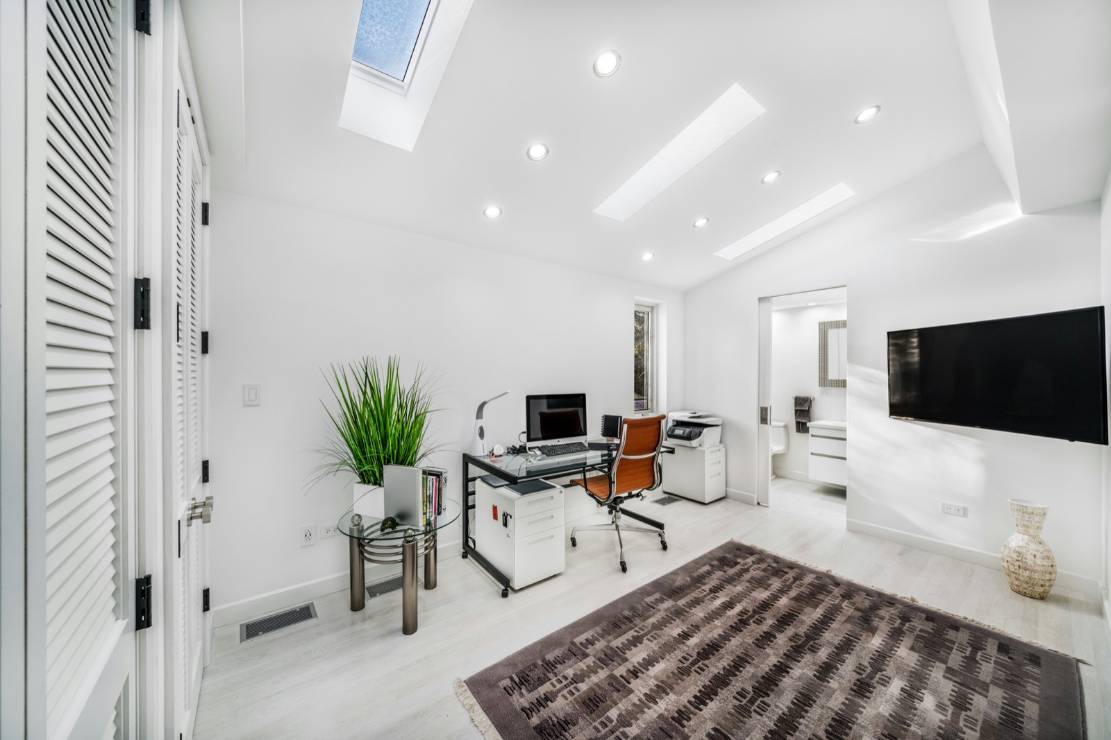 Calm, bright minimalist room with natural light from a skylight